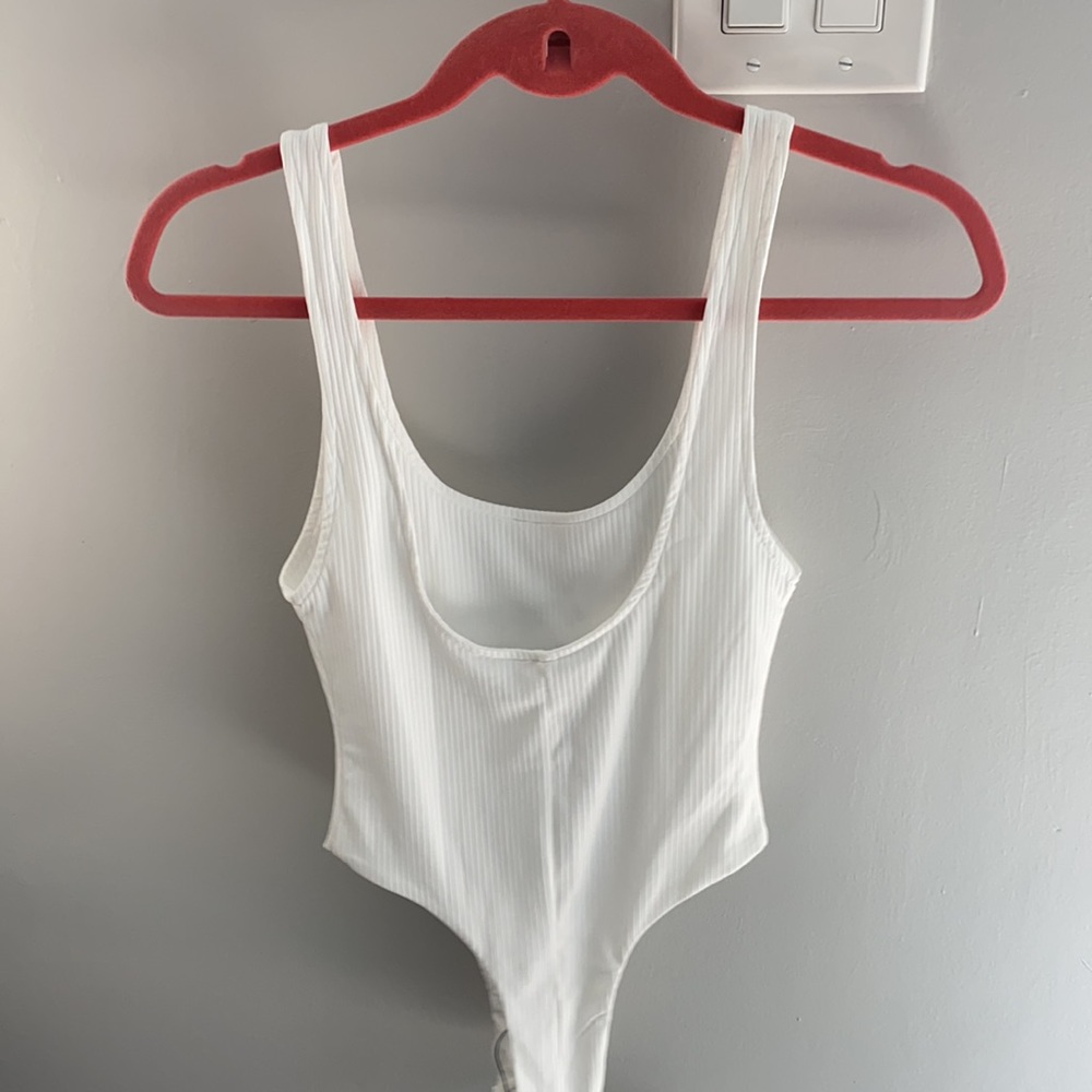 Adorable and flattering white ribbed body suit